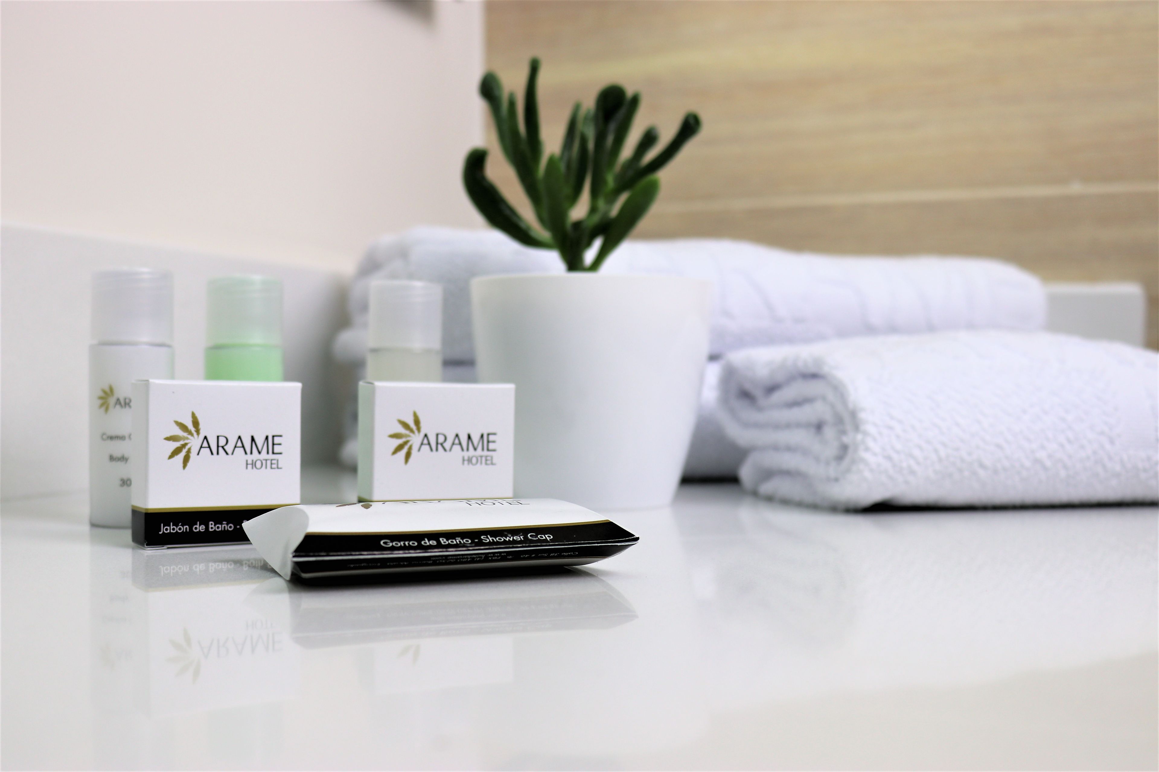 A bathroom setting with toiletries, a shower cap, and towels.