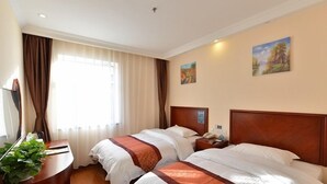 A hotel room with two beds, a desk, a mirror, and a window with curtains. - GreenTree Inn BeiJing Haidian Shijingshan N Univ of Tech Htl (Beijing)