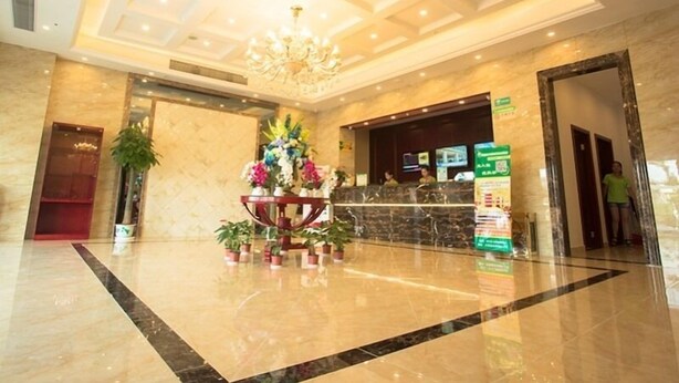 A spacious lobby with a marble floor, a reception desk, and a chandelier. - GreenTree Inn SuZhou International Film City South JinShan Road Express Hotel (Suzhou)