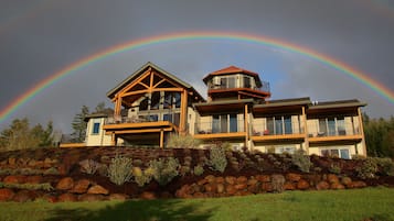 Enjoy a picturesque view from the upper-level balcony overlooking the beautifully maintained garden and surrounding landscape.