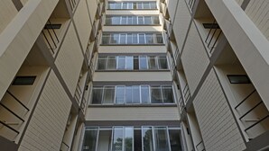 En byggnad med flera våningar och en symmetrisk fasad, med balkonger och fönster på varje våningsplan.