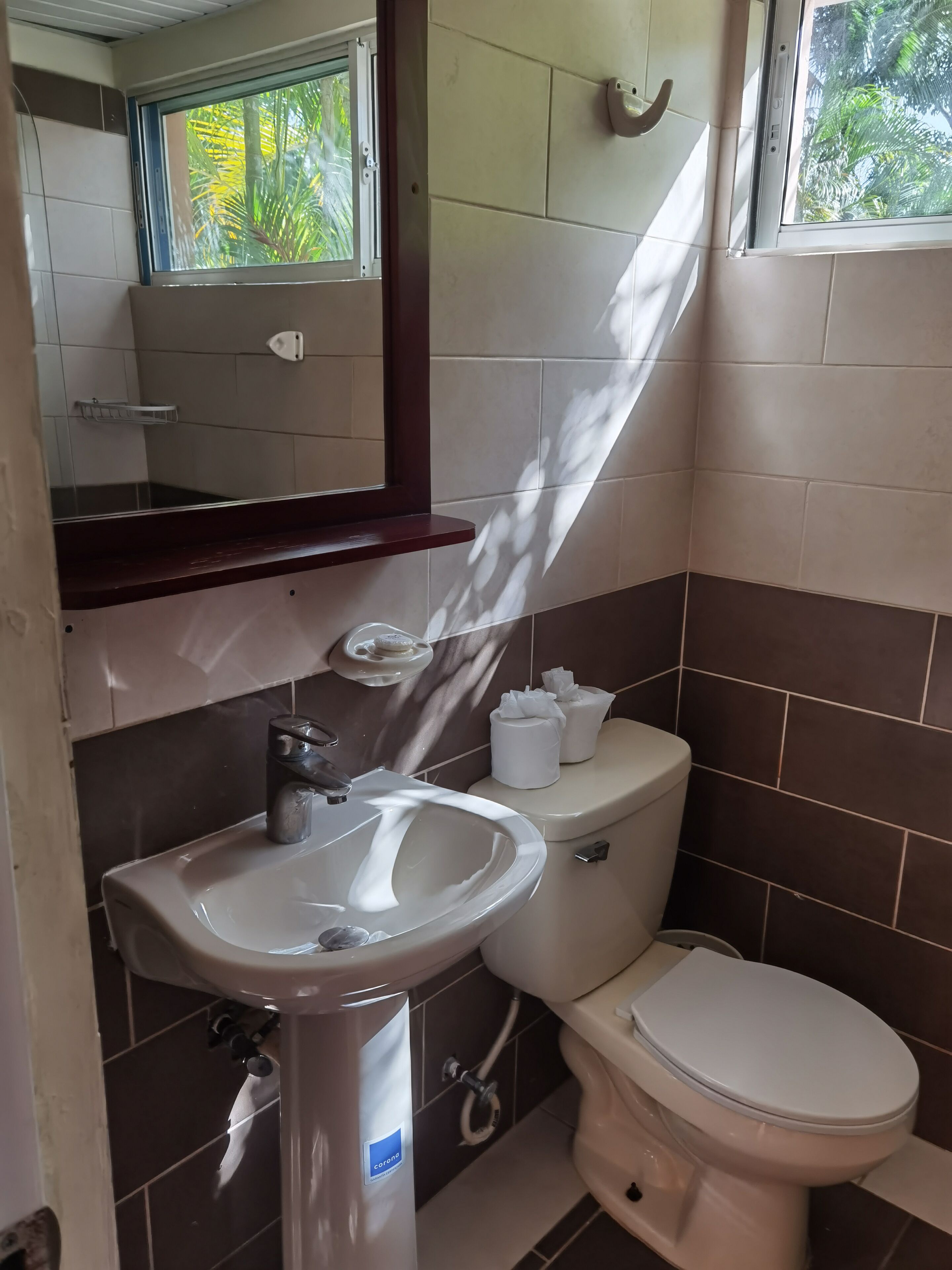 A bathroom with a white sink, a toilet, and a mirror above the sink.