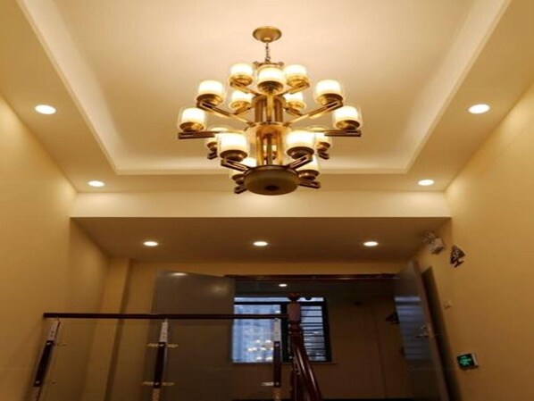 A chandelier with multiple light fixtures, a staircase with glass railings, and a recessed ceiling light. - Greentree Inn Mong Kok Express Hote (Suzhou)