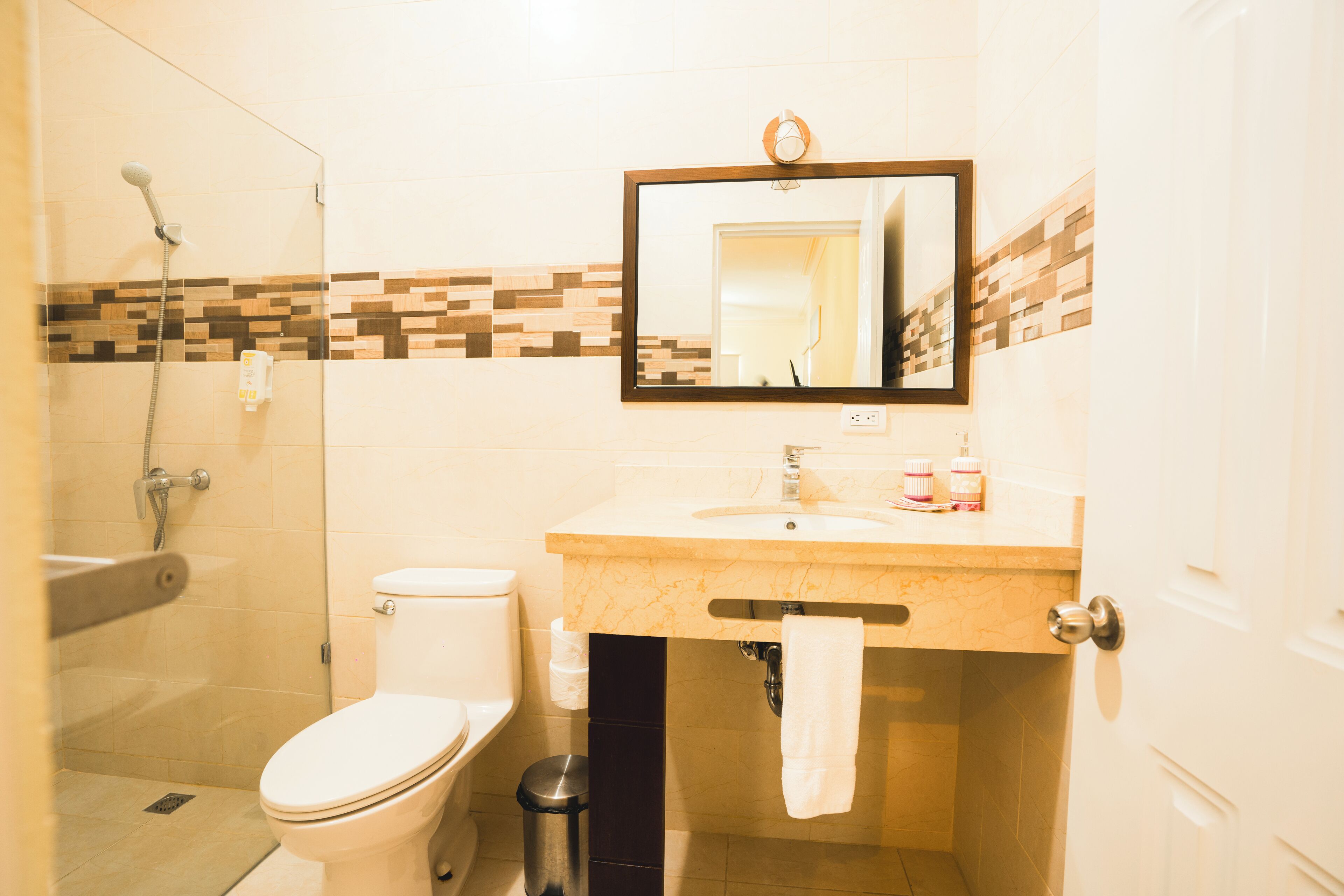 A bathroom with a toilet, sink, and shower.