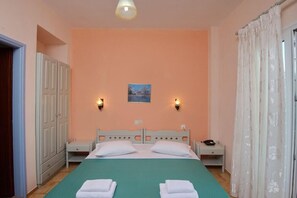 A bedroom with a bed, two bedside tables, a nightstand, a wardrobe, and a painting on the wall.