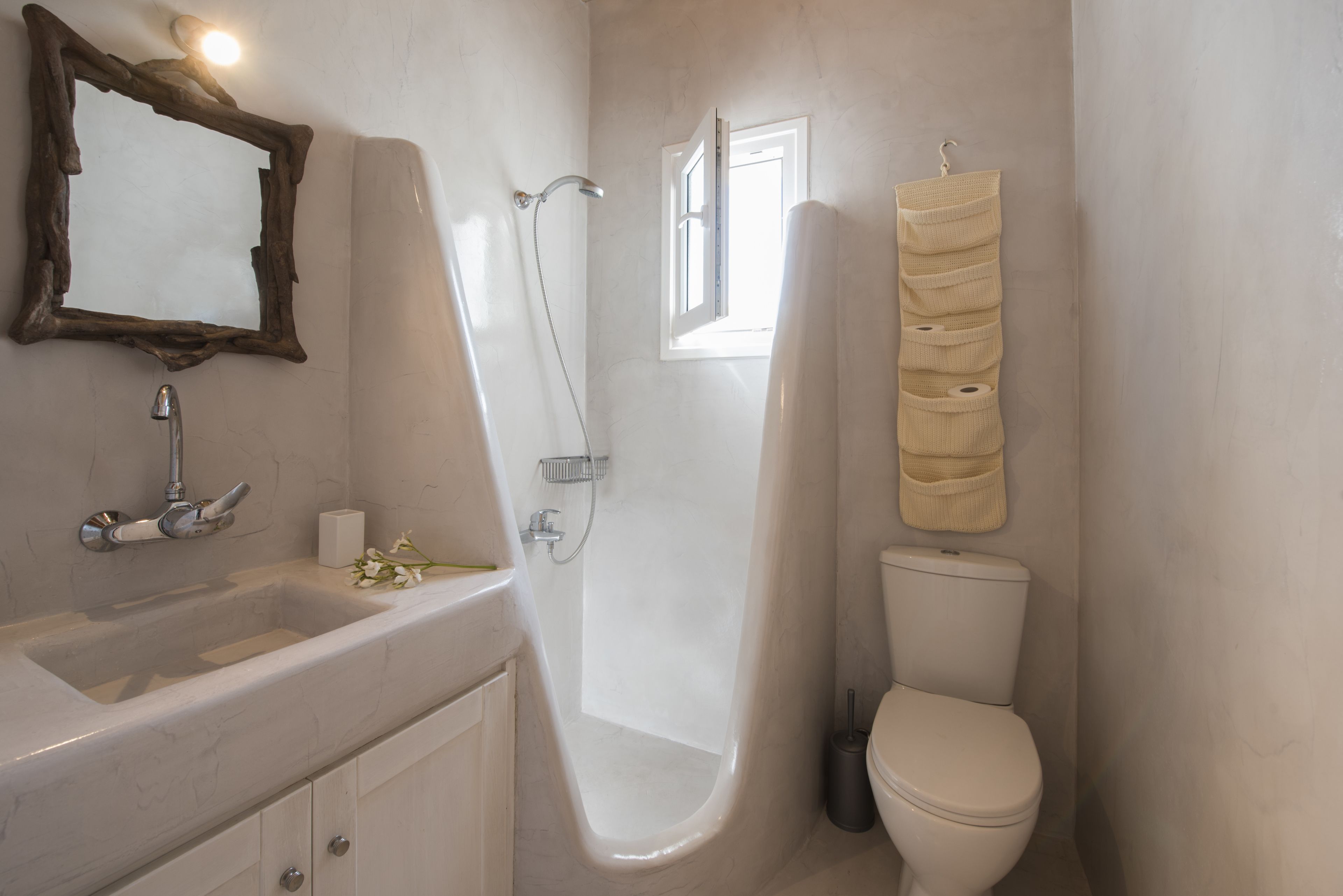 A bathroom with a bathtub, toilet, sink, and a mirror.
