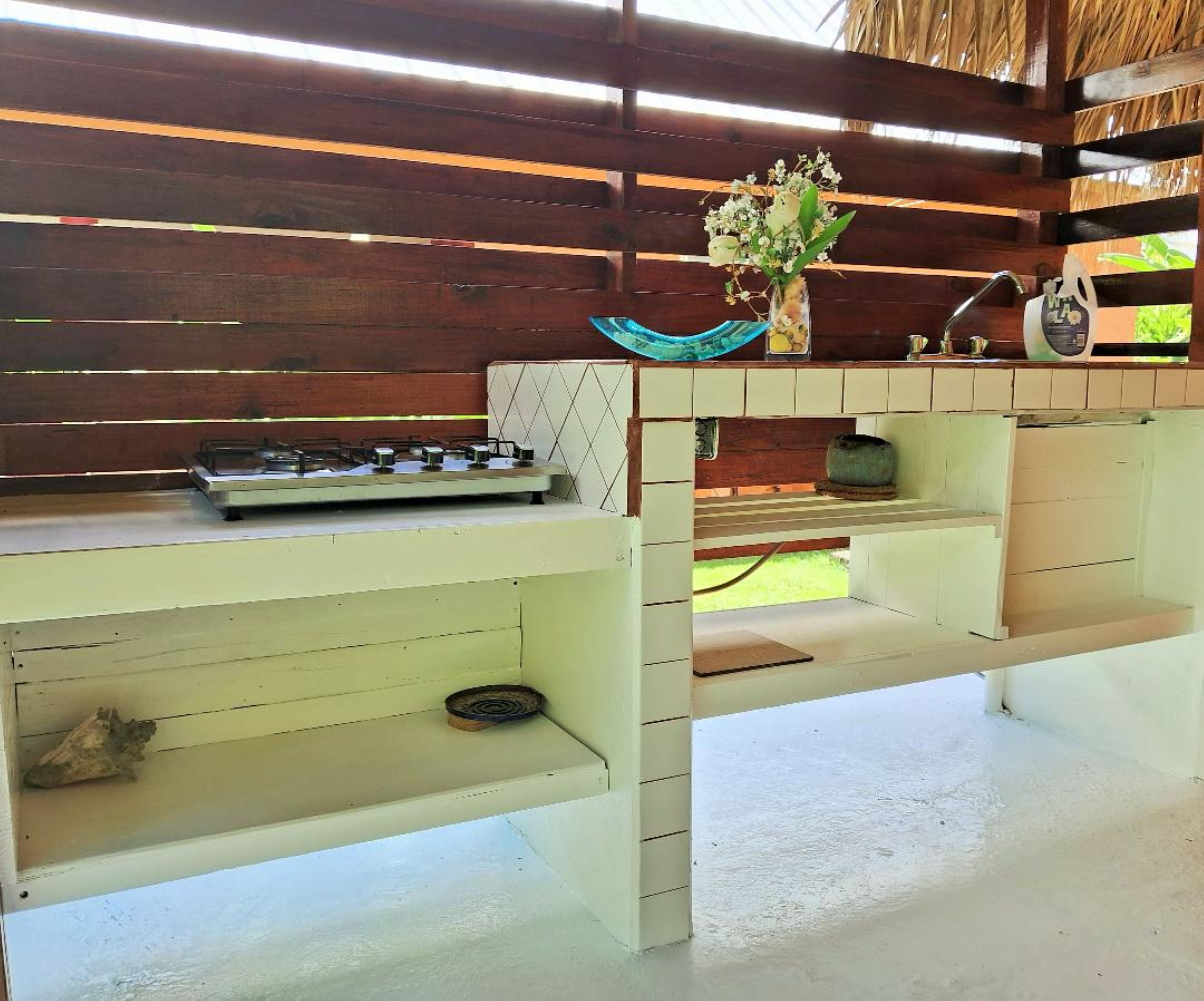 A kitchen with a gas stove, a sink, and a countertop.