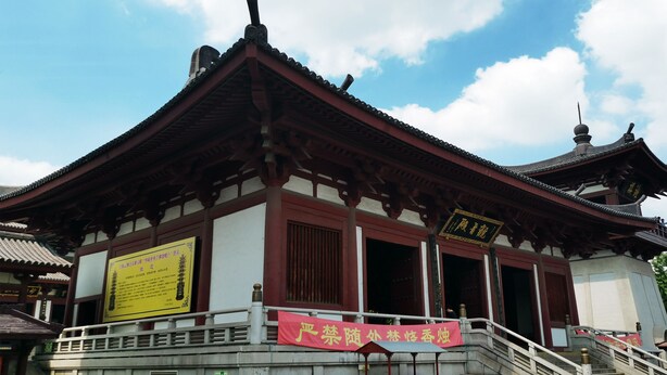 A traditional building with a tiled roof, wooden beams, and a red and white facade. - Wyndham Shanghai Nanxiang (Shanghai)