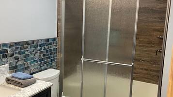 Combined shower/tub, hair dryer, towels, soap
