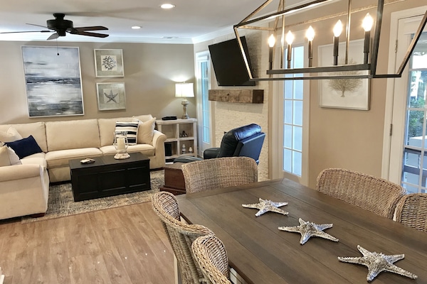 Roomy Great Room w/comfy sectional, 55” SmartTV & decorative stone fireplace.