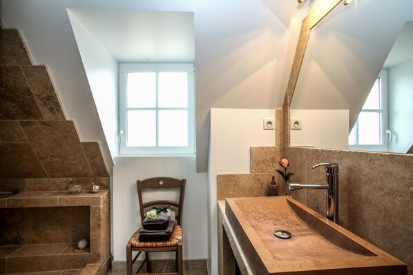 A bathroom with a stone sink, a mirror, and a window. - BISE stylish 1600 SF wifi (Vitrac)