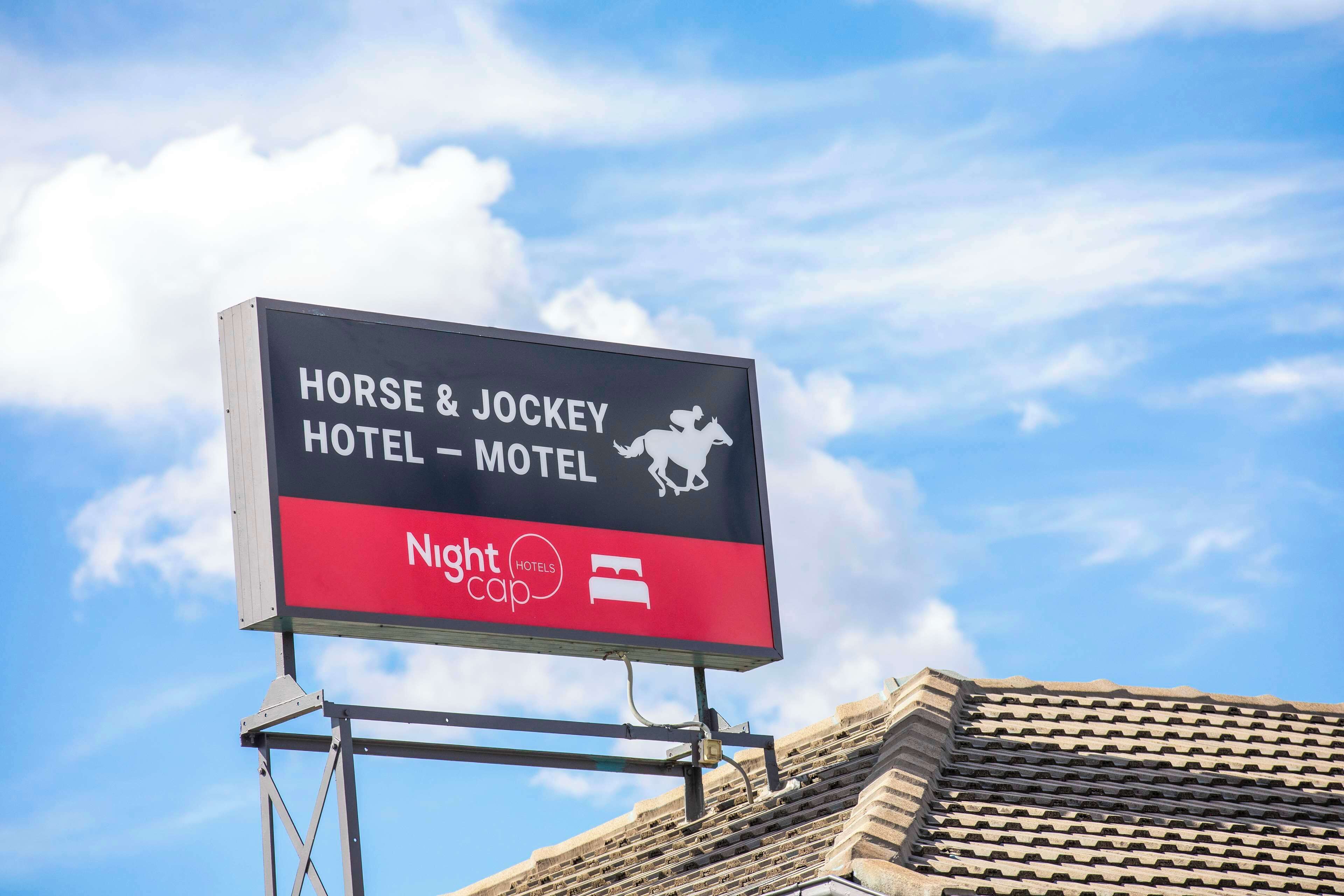 A sign for the Horse & Jockey Hotel & Motel with a Nightcap logo.