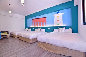 A hotel room with two beds, a large wall mural, and a wooden floor. - Cimei Inn (Hengchun)