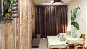 A bedroom with a bed, a ceiling fan, a wall-mounted shelf with decorative items, and a curtain. - Misty Forest II - 9 Pax Next To Night Market (Tanah Rata)