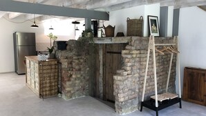 A rustic kitchen with exposed beams, a brick wall, and a wooden cabinet. - Domaine des 4 roses -SPA - Heated swimming pool- SPA 17 minutes from Strasbourg (Furdenheim)