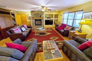 A cozy living room with a fireplace, sofas, and a coffee table. - Colorado Family Reunion and Wedding Headquarters (Jefferson County)