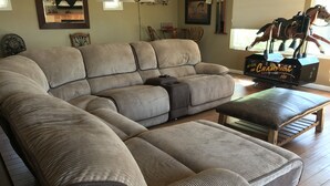 A large, beige, upholstered sectional sofa with a wooden coffee table and ottoman. - Temecula Winery Estate Villa at Longshadow Ranch Winery             Permit #0204 (Temecula)