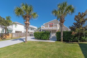 A residential area with a house featuring a balcony and a red door. - Walk to Dining,& the Beach–Chic Cottage, Bikes, Kayak, Golf Cart Available (Santa Rosa Beach)