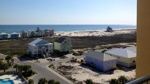 A beachfront property with multiple houses, a swimming pool, and a beach view. - Indies 704 | 3BR/2BA Penthouse Condo | Sleeps 9 | Gulf Views & Heated Pool (GULF SHORES)