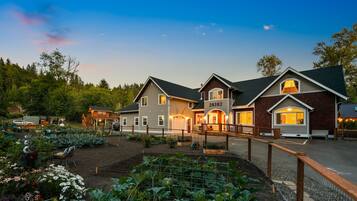 A large house with a number "20302" on the front, surrounded by a garden and a fence.