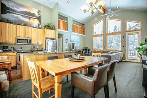 Enjoy meals in the well-appointed kitchen and dining area with a large window offering a view of the surrounding landscape.