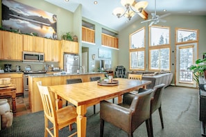 Enjoy meals in the well-appointed kitchen and dining area with a large window offering a view of the surrounding landscape.