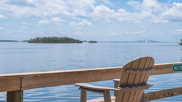 A wooden deck with a chair and a sign that reads "NO FISHING." - Condos at Wander Residences in Tierra Verde (Tierra Verde)