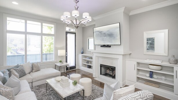 A modern living room with a fireplace, a large TV, and a cozy seating area. - FREE NIGHT DEAL! DOWNTOWN 1MI TO BROADWAY! #3 of 6 HOMES! Rooftop Deck BY VANDY! (Nashville)