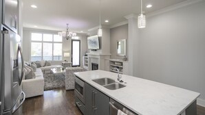 A modern kitchen with a large island, stainless steel appliances, and pendant lighting. - FREE NIGHT DEAL! DOWNTOWN 1MI TO BROADWAY! #3 of 6 HOMES! Rooftop Deck BY VANDY! (Nashville)