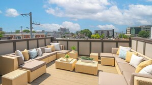 A rooftop terrace with wicker furniture, a view of the city, and a clear sky. - FREE NIGHT DEAL! DOWNTOWN 1MI TO BROADWAY! #3 of 6 HOMES! Rooftop Deck BY VANDY! (Nashville)