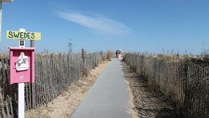 A pathway with a sign reading "SWEDES" and a pink mailbox. - WALK to Beach, Town of Dewey w/LARGE Heated POOL thru Oct, HOT TUB and fire pit! (Dewey Beach)