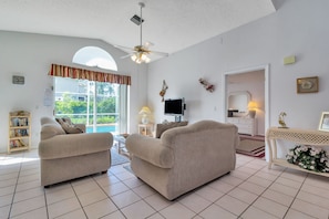 Living room with sliding doors leading to the pool area
