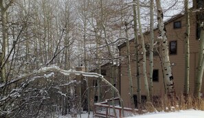 A snow-covered landscape with a building that appears to be a residential structure.