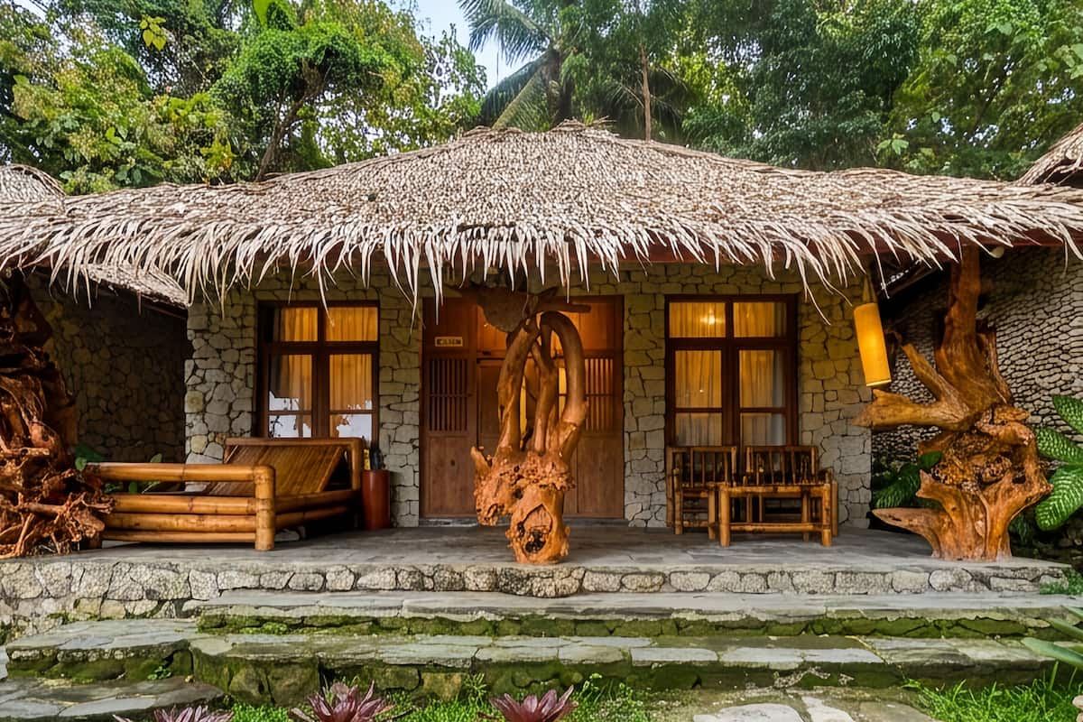 A rustic hut with a thatched roof, stone walls, and a wooden door.
