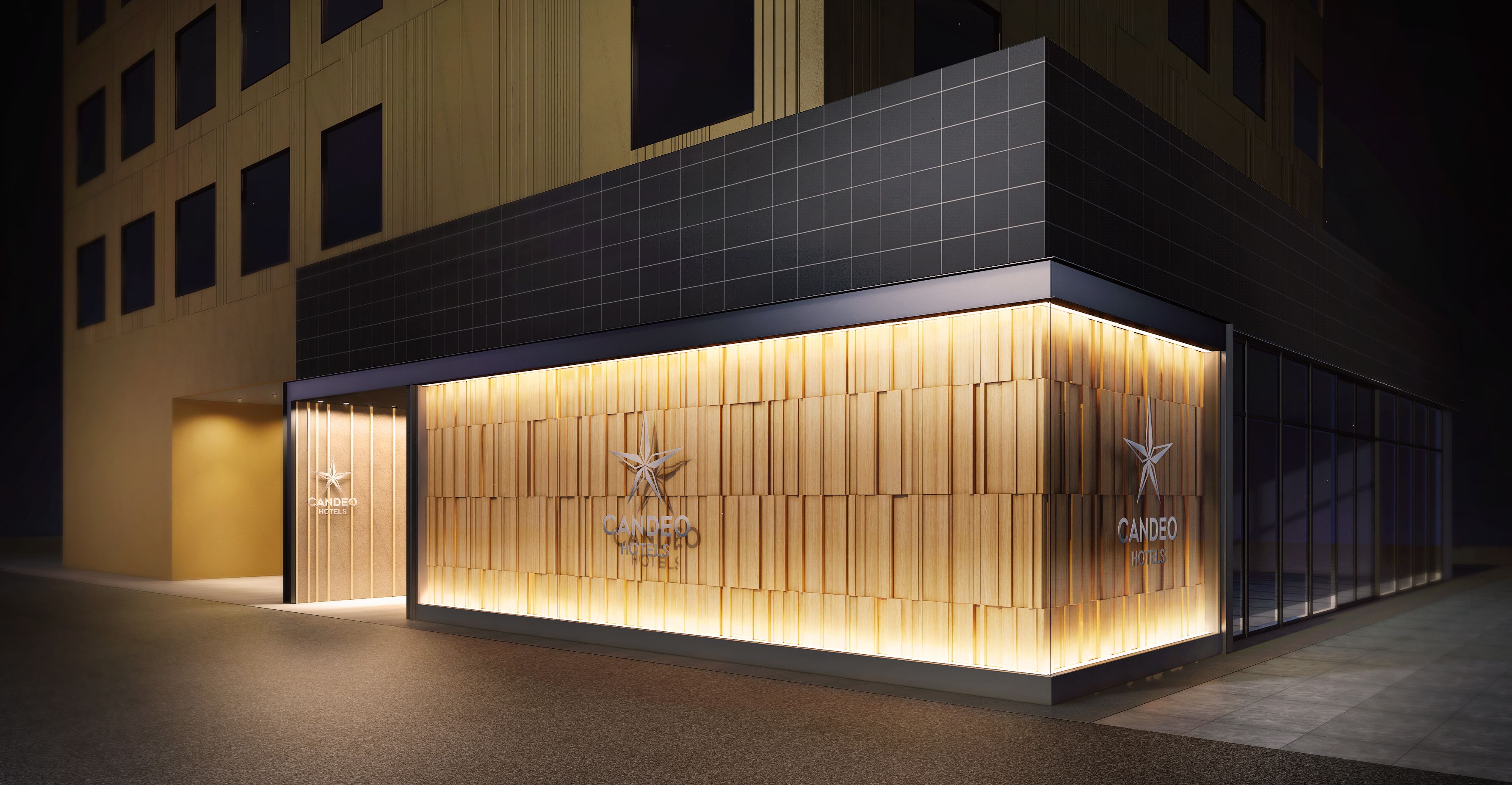 A hotel facade with a modern design, featuring a prominent logo and a well-lit entrance.