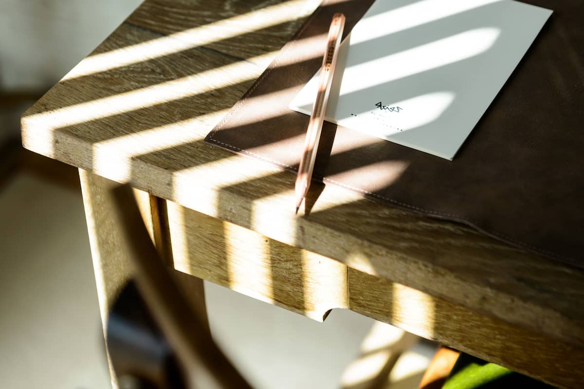 A wooden table with a geometric pattern and a piece of paper on it.