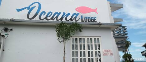 The exterior of Oceana Lodge with a clear sign indicating the entrance.