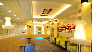 A hotel lobby with a reception desk, seating area, and a corridor leading to other rooms. - Grand Park Hotel Excel Kisarazu (Kisarazu)