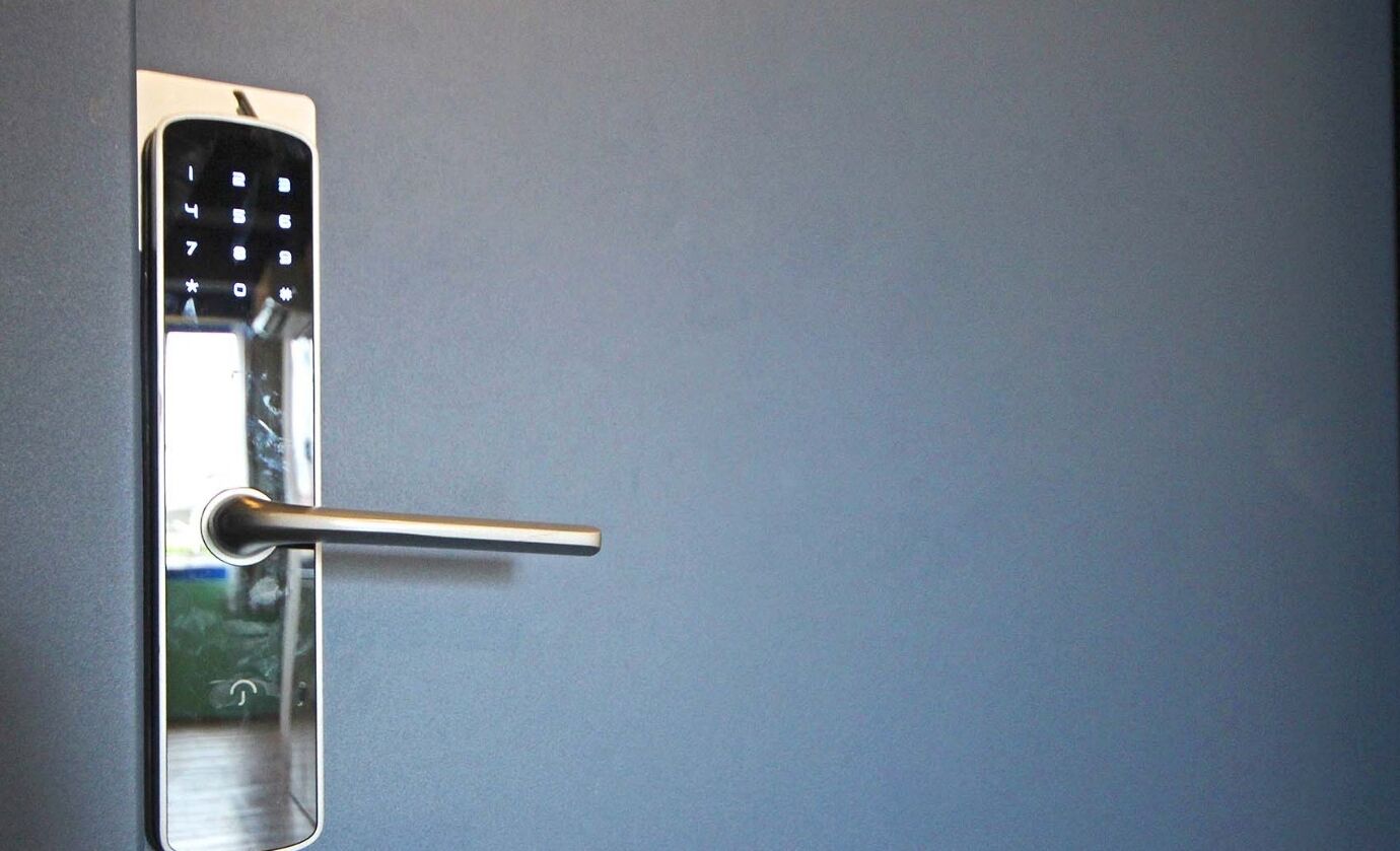 A modern door with a keyhole and a handle.