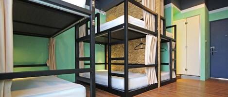 Una habitación con literas, un armario y una puerta.