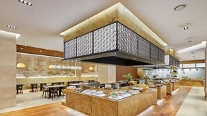 A modern restaurant with a central island, seating area, and a decorative ceiling. - Skypark Central Seoul Pangyo (Seongnam)