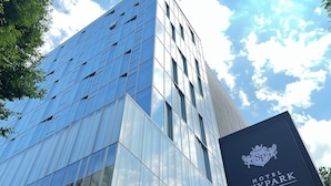 A modern hotel building with a reflective glass facade and a sign indicating it is the Hotel Skypark in Central Seoul. - Skypark Central Seoul Pangyo (Seongnam)