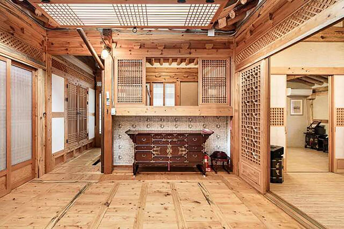 A traditional Japanese room with tatami flooring, a low wooden bench, sliding doors, and a shoji screen.