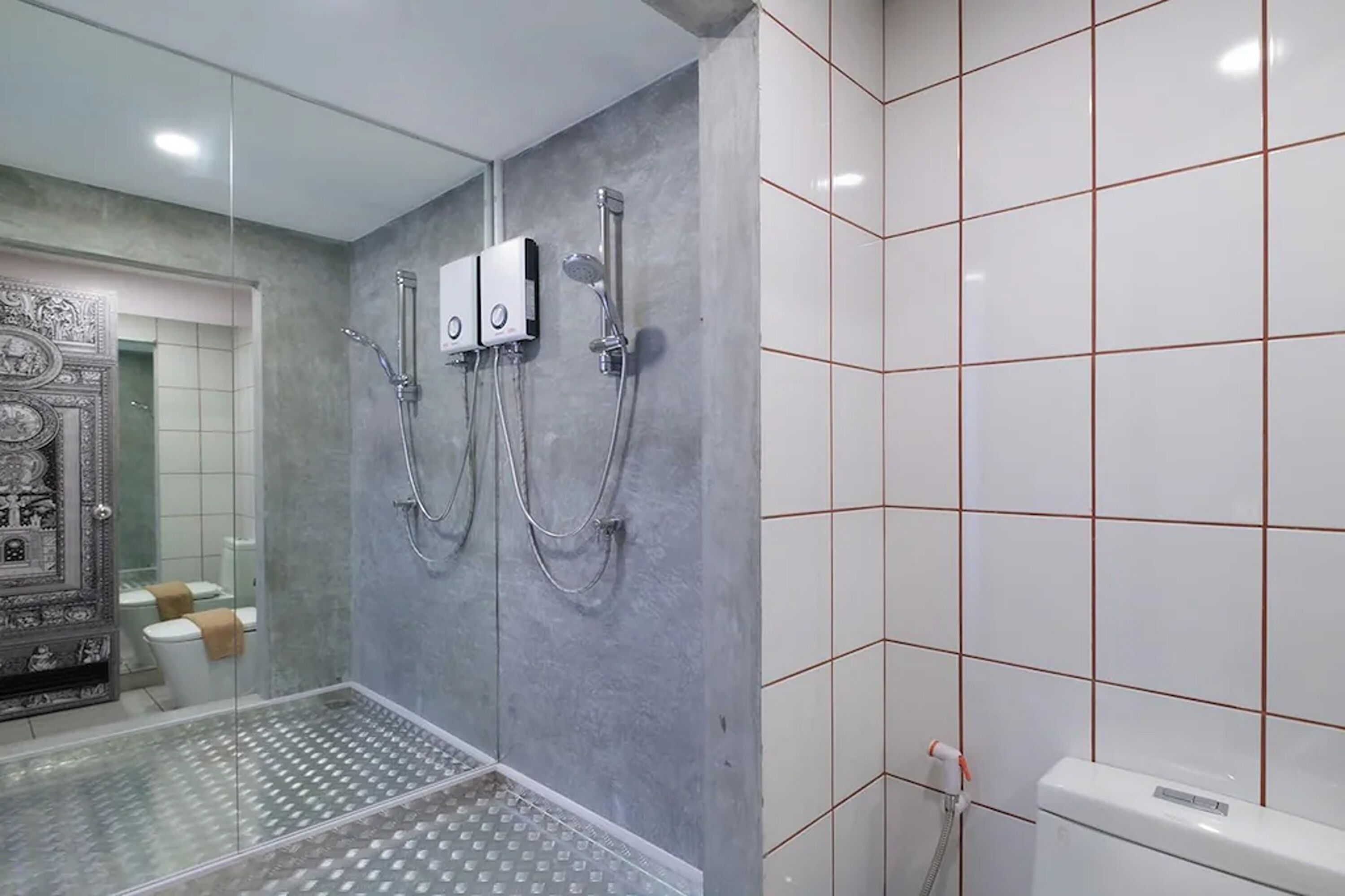 A modern bathroom with a glass shower enclosure, a toilet with a towel, and a white toilet paper holder.