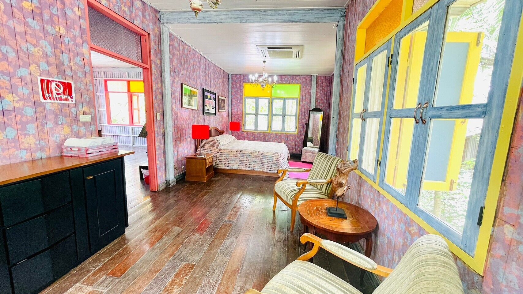 A room with a bed, a desk, a chair, and a window.