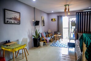 Deluxe Family Room with Balcony | Living area | LCD TV
