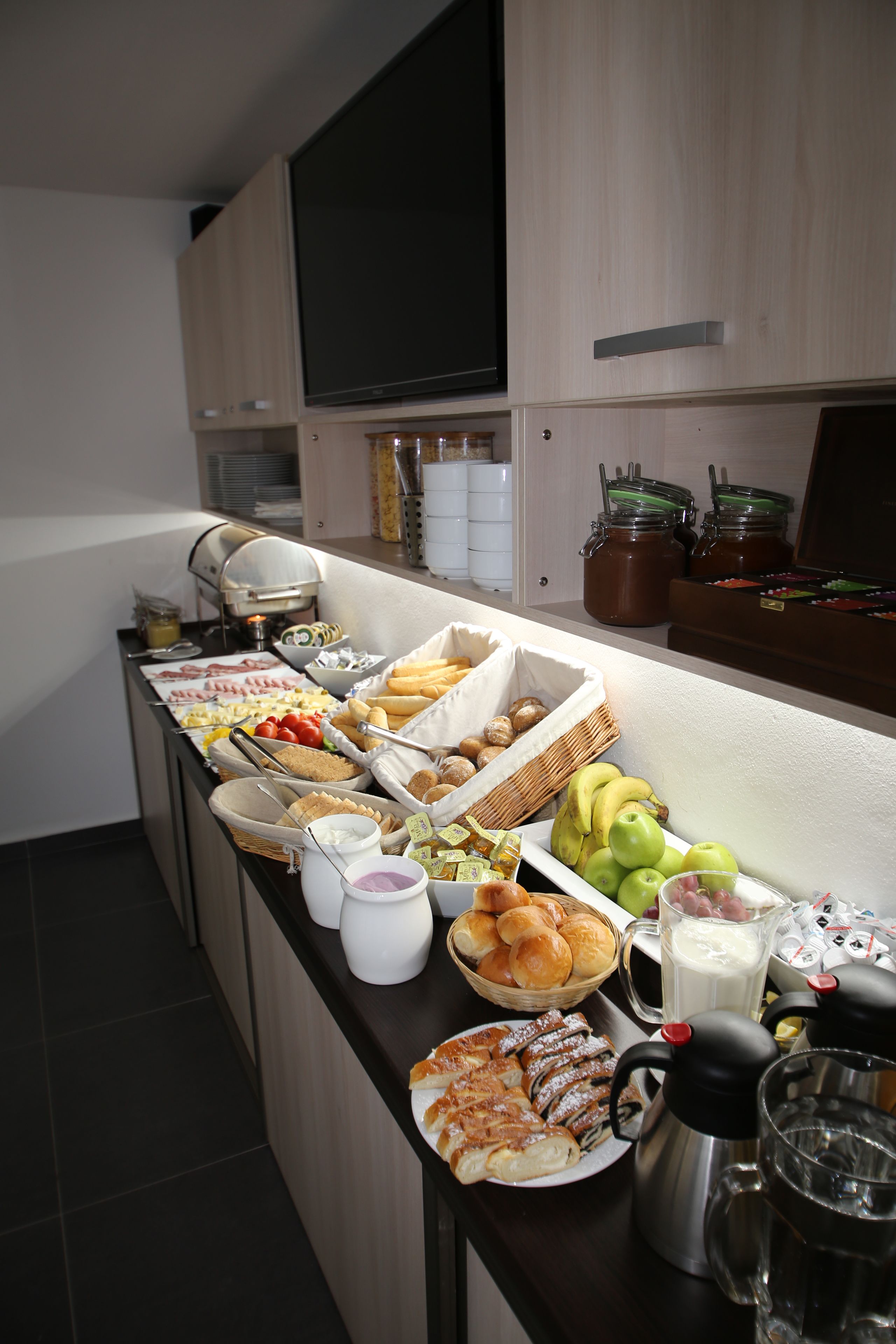 A buffet spread with various food items and beverages.