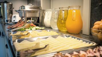 A buffet with various food items and beverages.