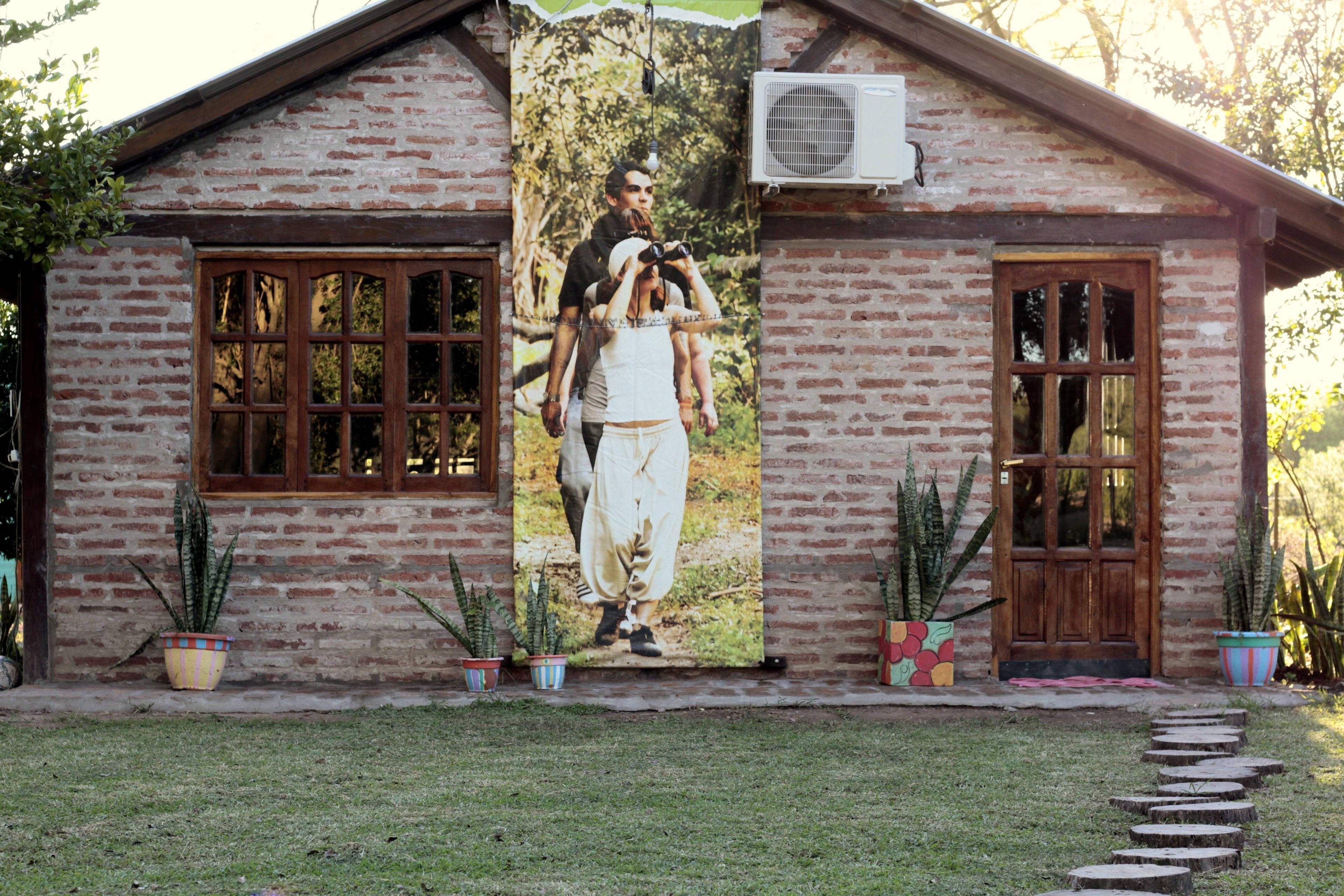 A brick building with a large poster of a man and a woman on the front.