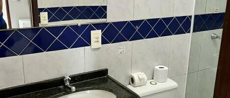 A bathroom with a sink, toilet, and shower.